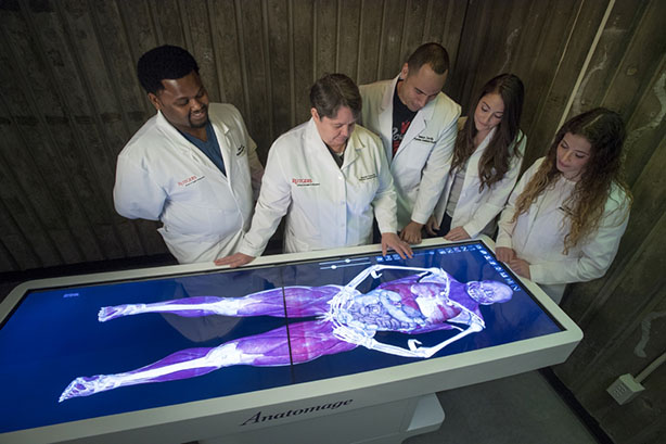 Virtual Dissection Table Demonstration Rebekah J. Thomas, center, an assistant professor at the School of Health Professions, demonstrates how to operate the school’s new virtual dissection table.