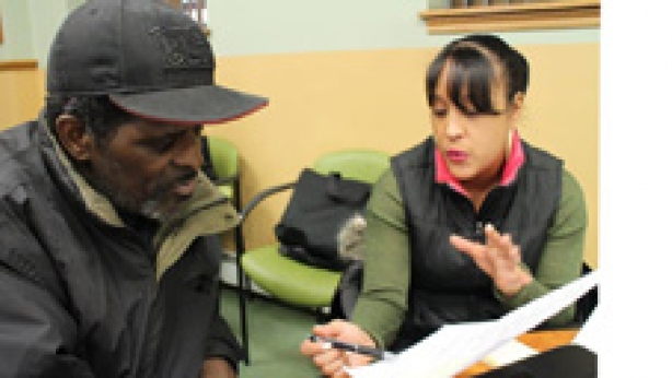 Counselor helping an individual enroll in a health insurance plan.
