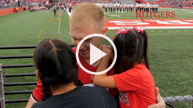 Andrew Geldreich hugs his two adopted sisters.