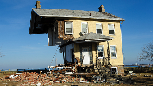 A tan-colored house that has been knocked in half due to Superstorm Sandy